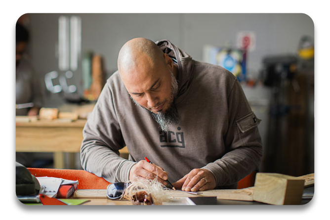 A man carving in a workshop for a course with Te Wananga o Aotearoa